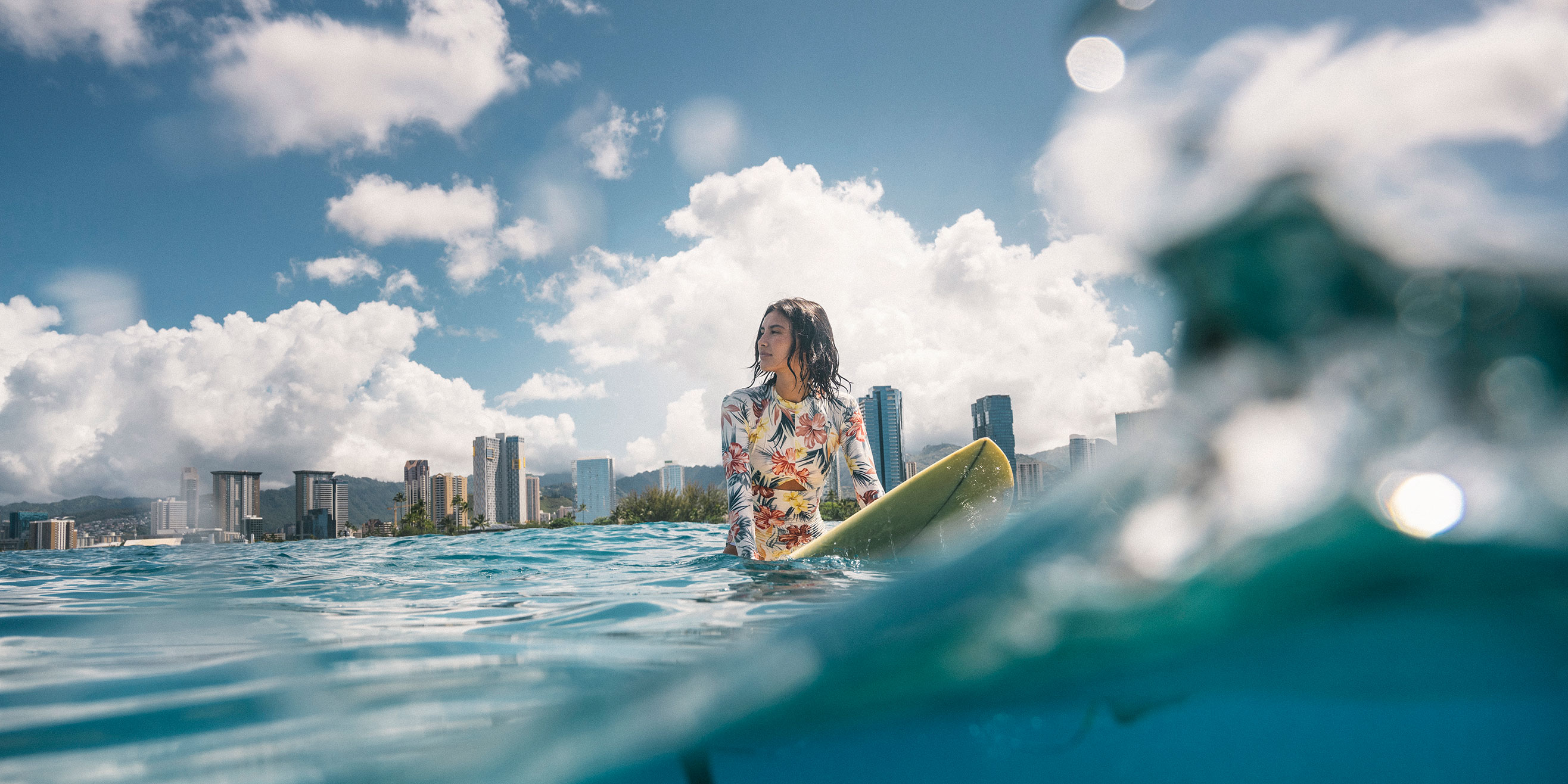 Woman surfing fronting Ward Village