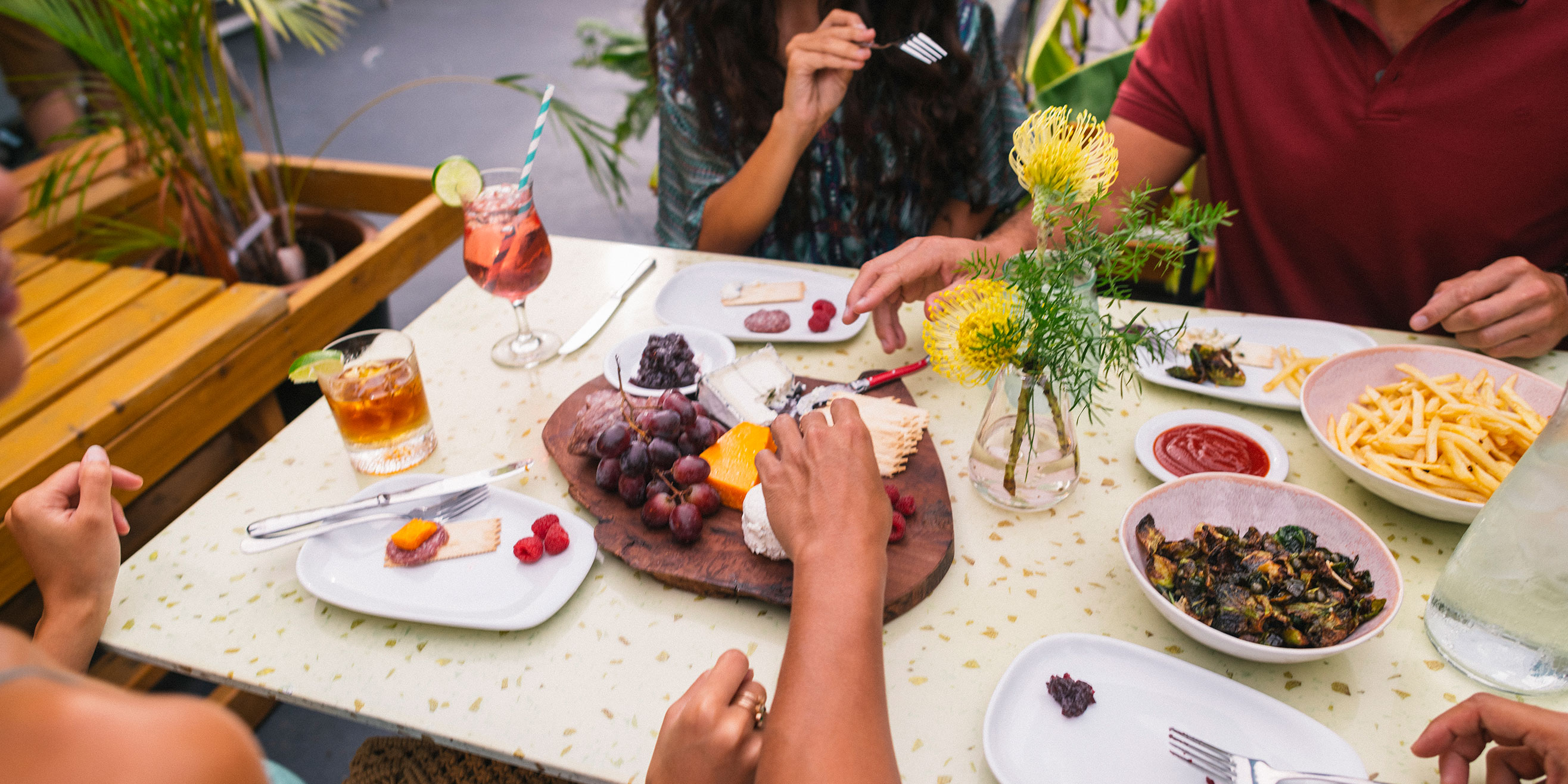 Conversation between 4 people over food and drink